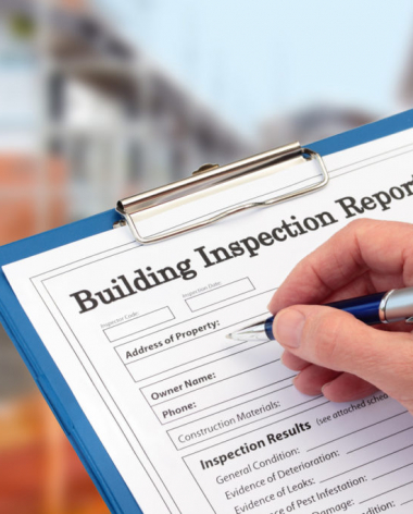 Buiding Inspector completing an inspection form on clipboard